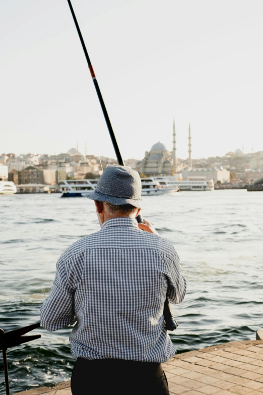 a man that is sitting down fishing