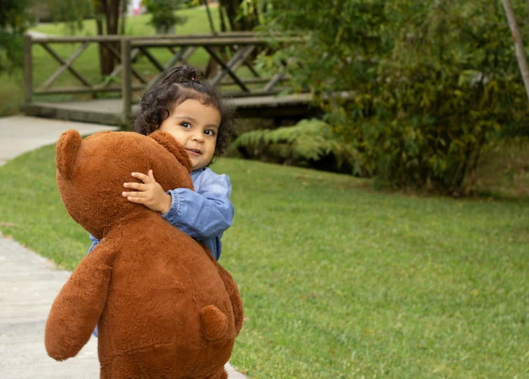 a  carries a large teddy bear