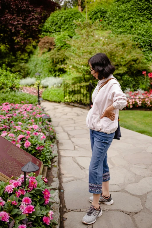 woman wearing flip flops and carrying a bag in park