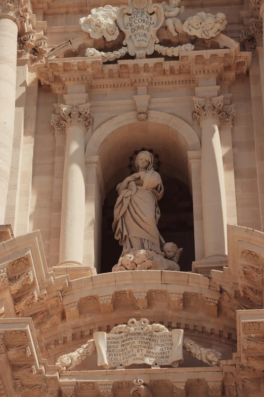 a large statue is attached to the side of a building