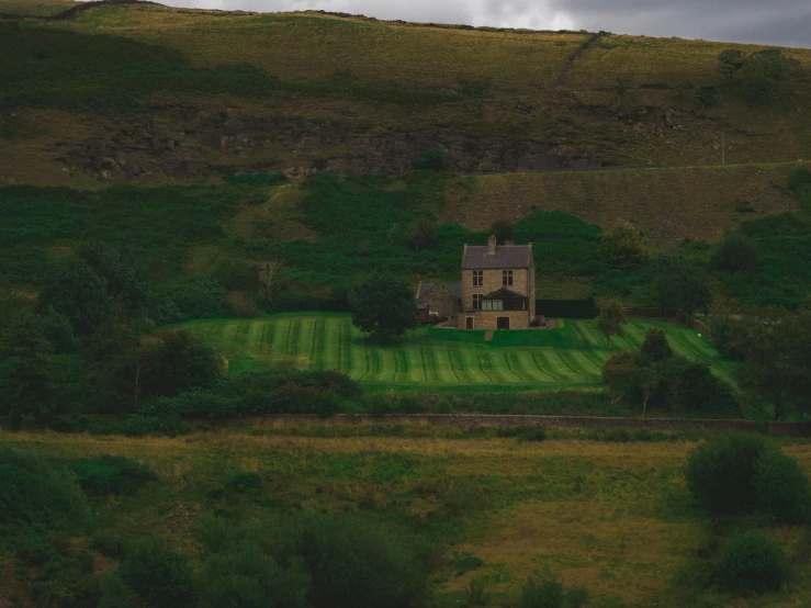 a very large house sitting in a green field