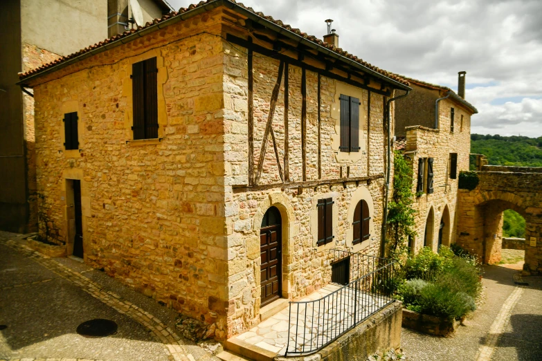 the building is made of brick and has windows and shutters