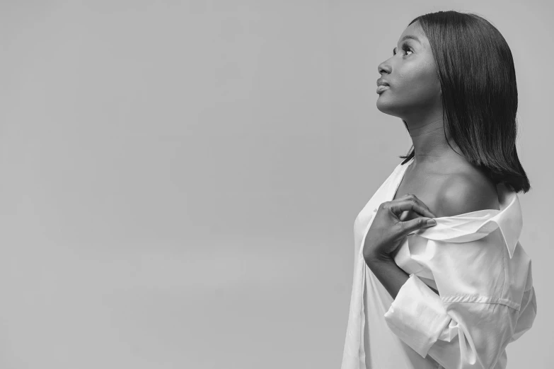 an african american woman standing with her arms behind her back