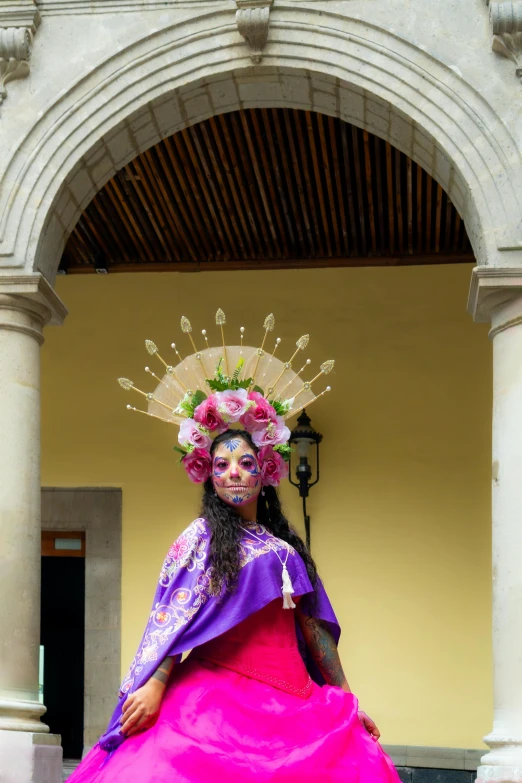 a woman wearing a mexican style dress posing for the camera