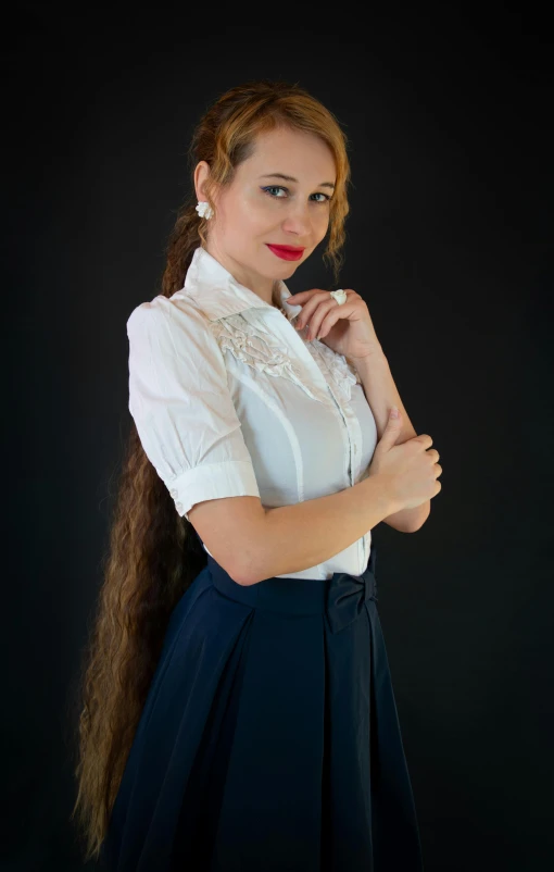 a woman with long brown hair wearing a white shirt