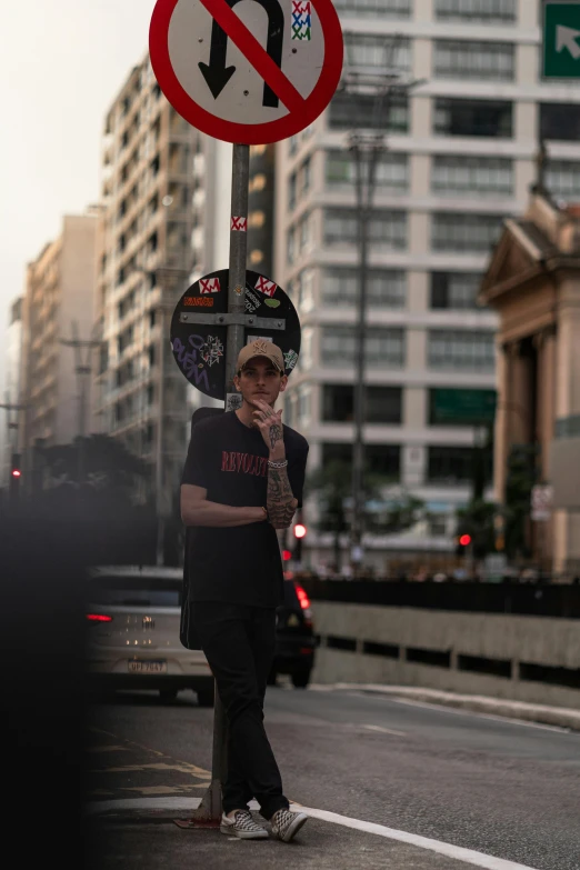 the person is standing in front of a street sign