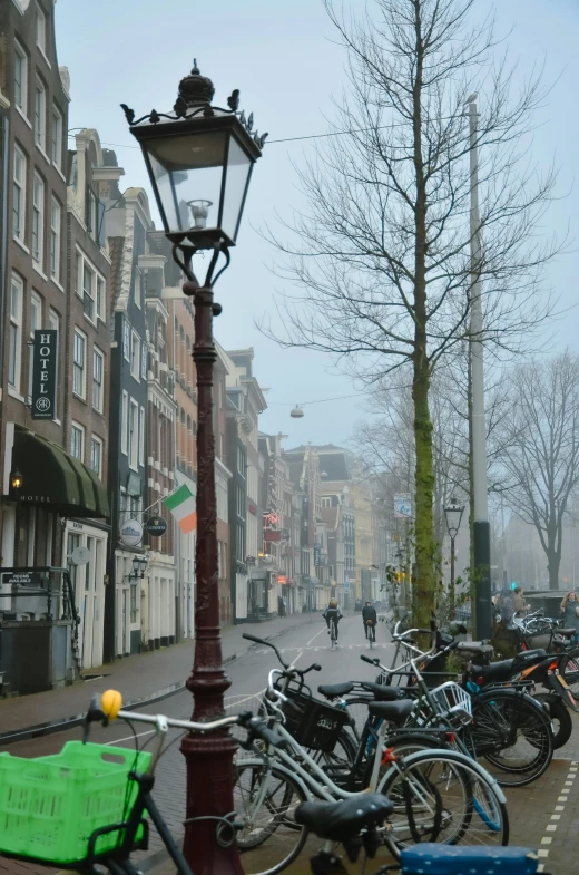 a street lined with bicycles on a cloudy day