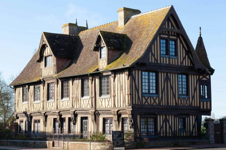 the old house has two storyed chimneys and arched windows