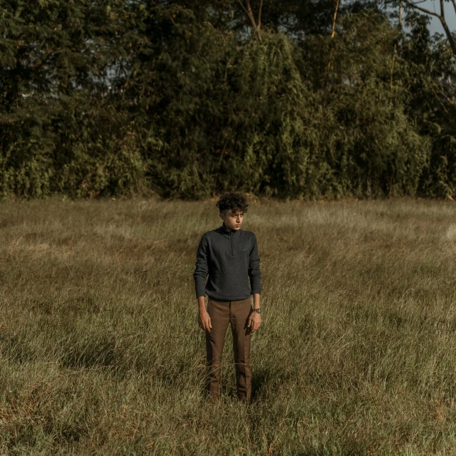 a  is standing alone in a grassy field