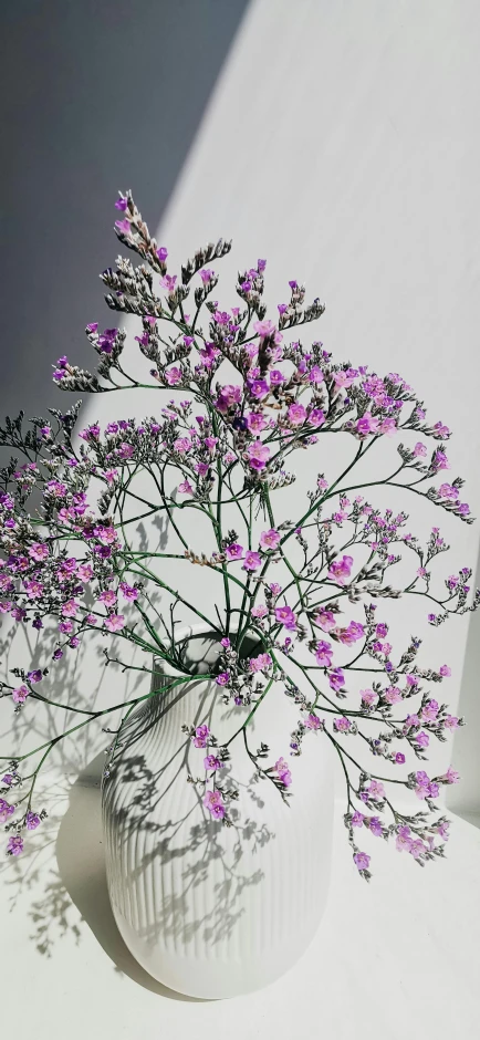 a large white vase with flowers in it