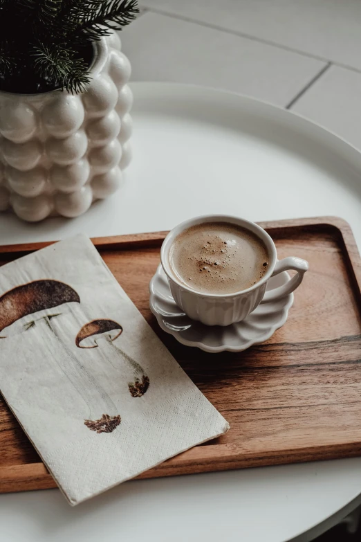 an artwork and a cappuccino on a table