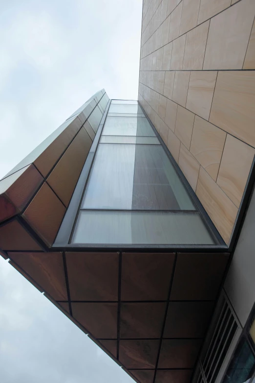 a tall brown building with some windows in it