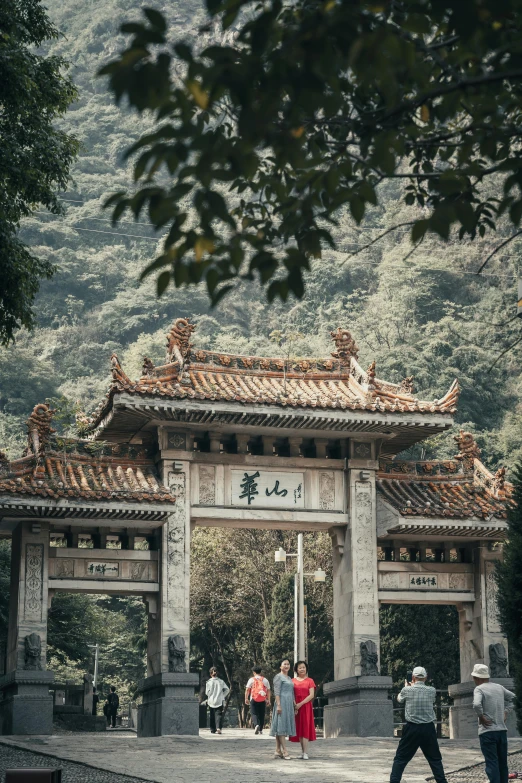 a group of people walking into a big gate