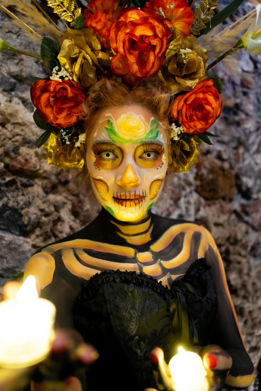 a lady with orange make up holding candles