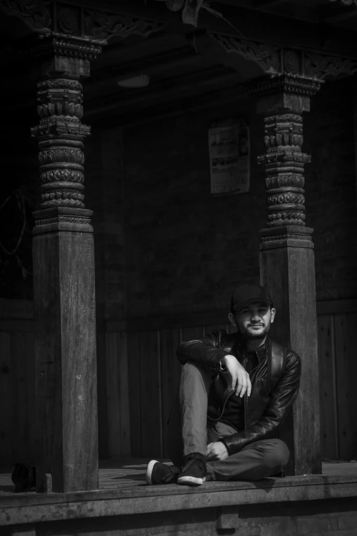 a man sitting on the steps posing for a picture