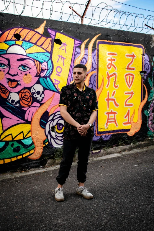 a man standing in front of a colorful wall