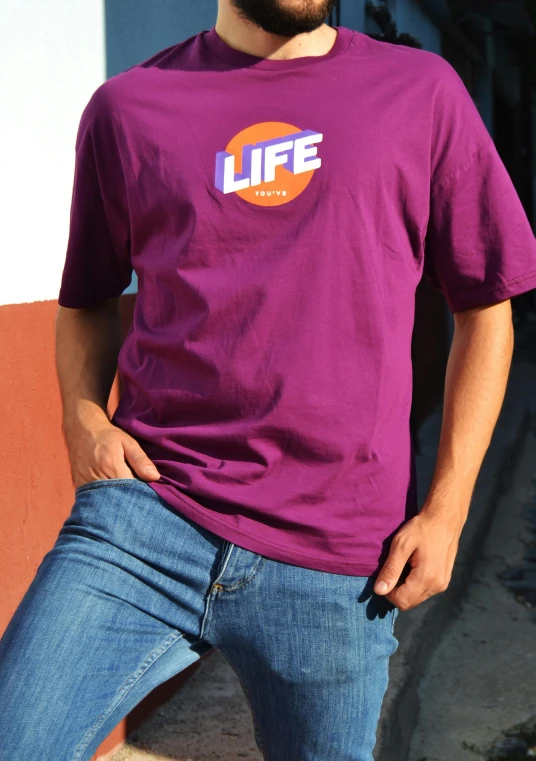 the man wearing a purple life t - shirt poses for a po