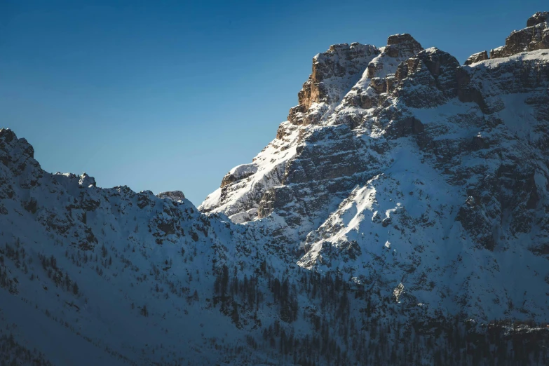 snow covered mountains in the distance and one skier standing on one ski board