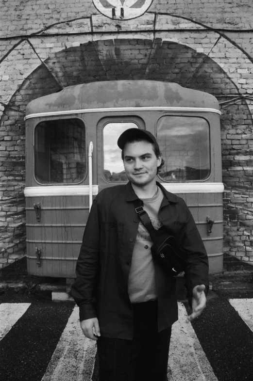 a black and white po of a man standing by a train