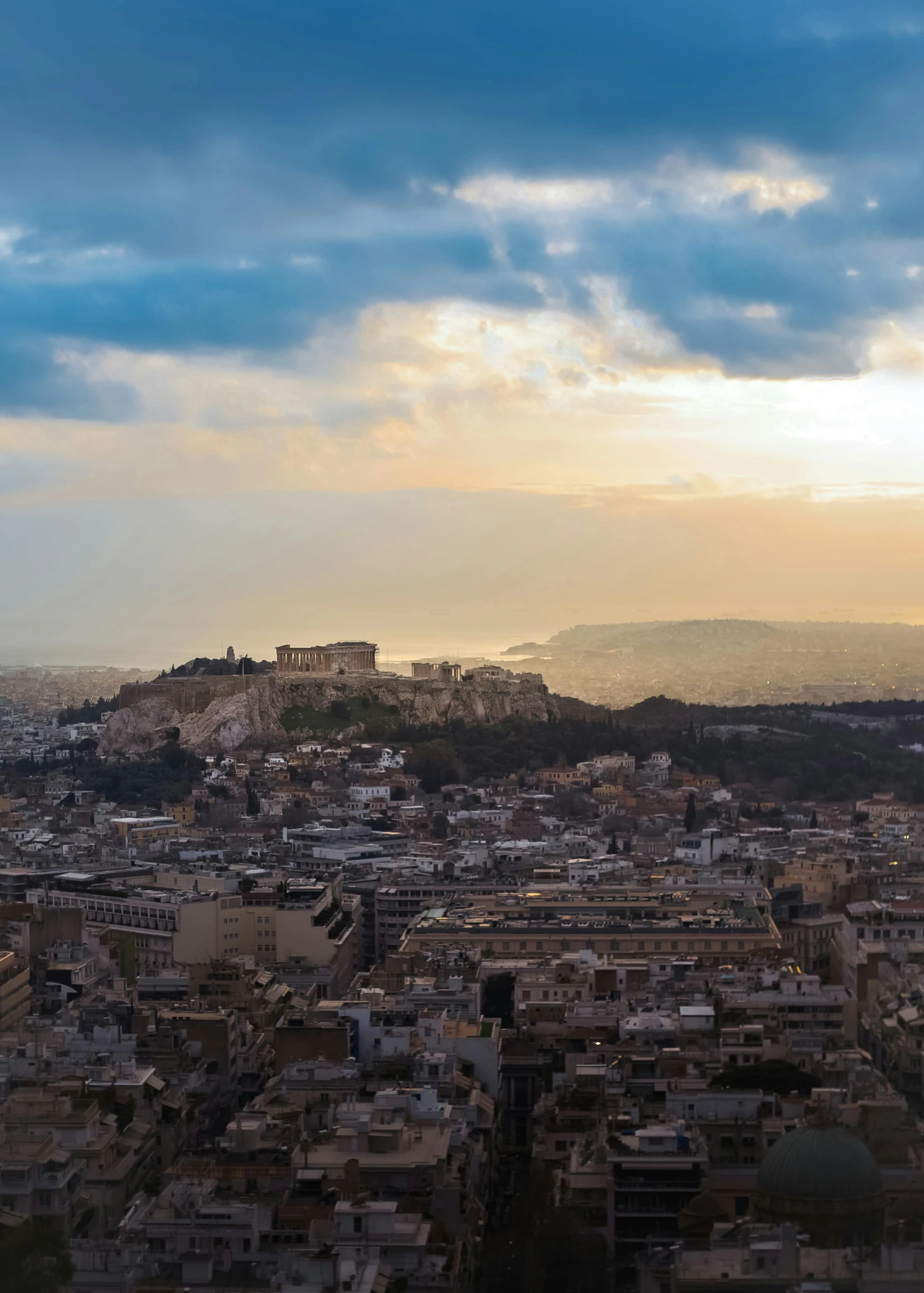 an aerial view of a city, with lots of buildings on the hill