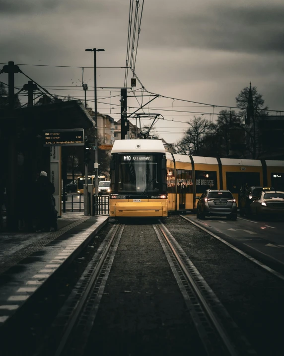 train on tracks at railway platform with cars waiting for signal