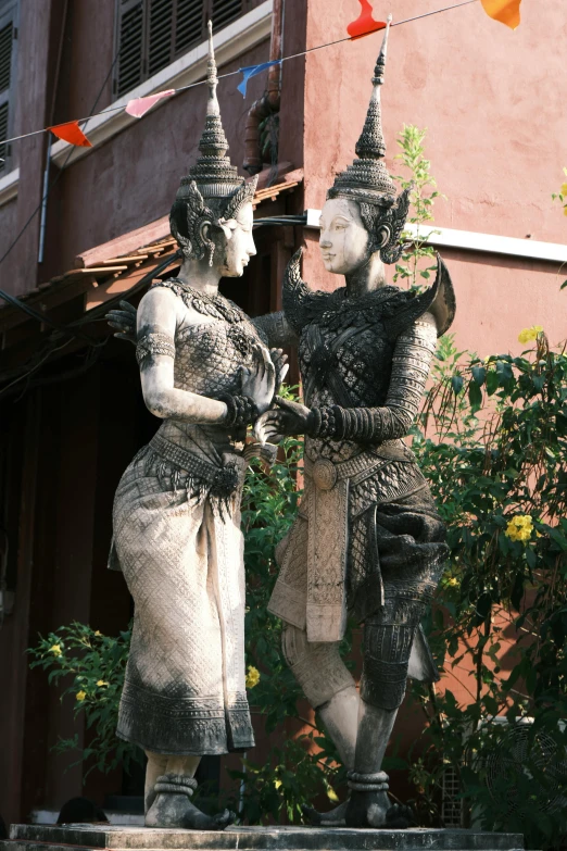 a couple of statues near each other on some steps