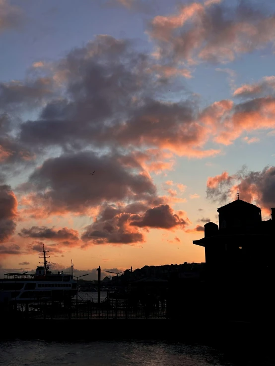 a sunset in a city next to a building