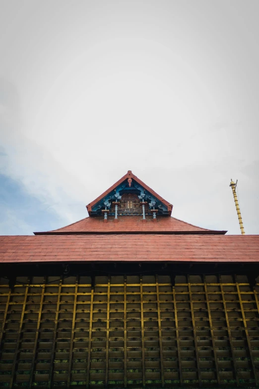 the roof of an old brick building has a clock on it