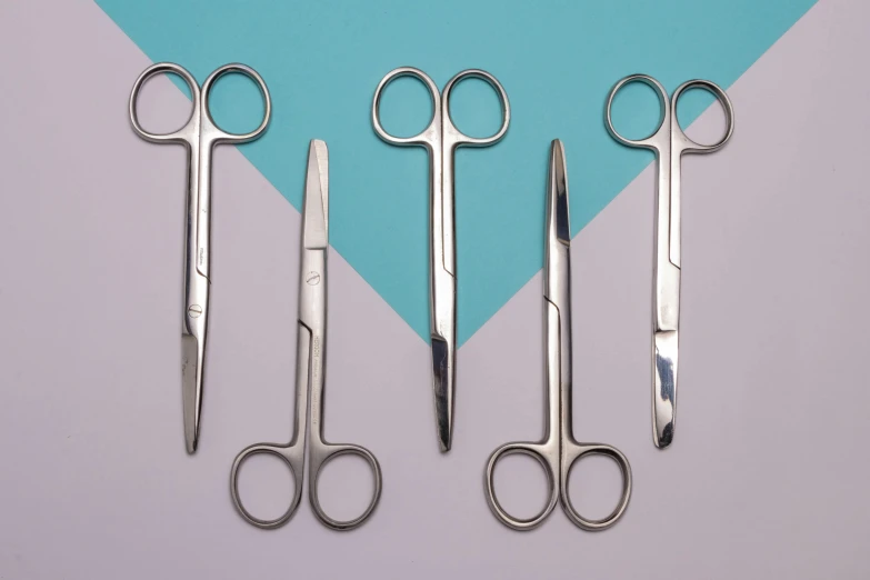 three pairs of scissors are shown with two different handles