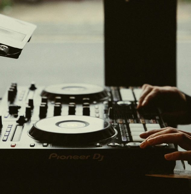 a person playing a dj's set with a remote control