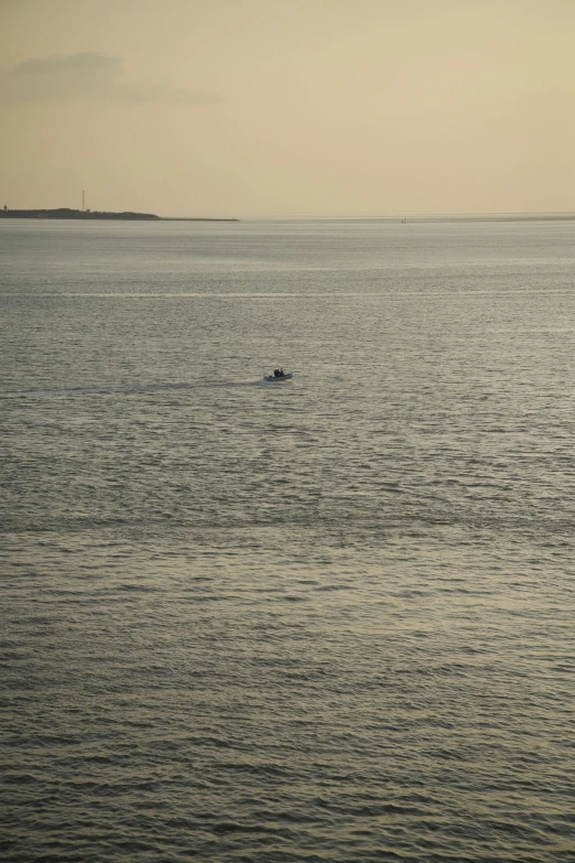 there is a lone boat out on the sea