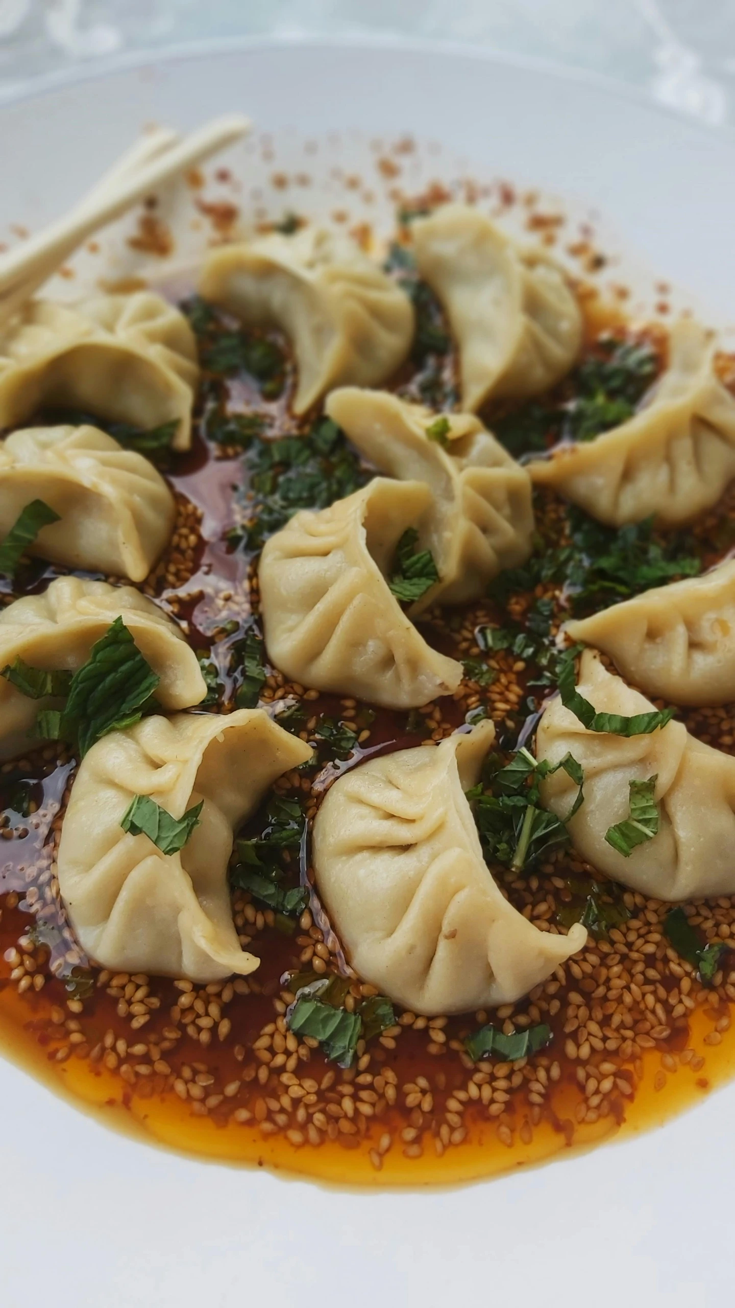 a plate topped with dumplings filled with sauce and sprinkles