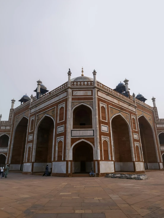 an ornate building in a courtyard on a sunny day