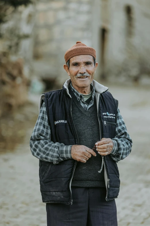 an older man with a mustache standing in the road