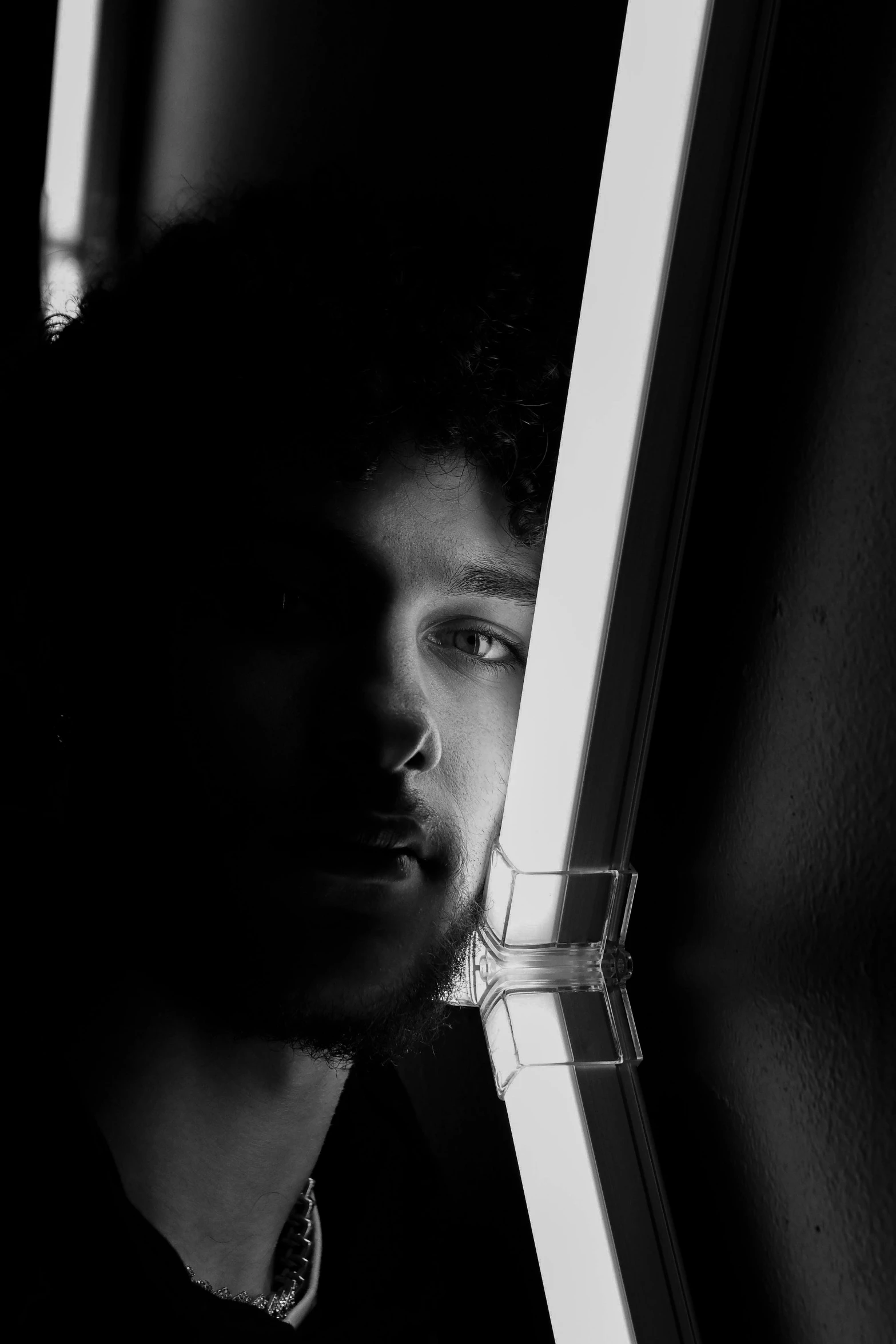 a man in a dark room looking at soing