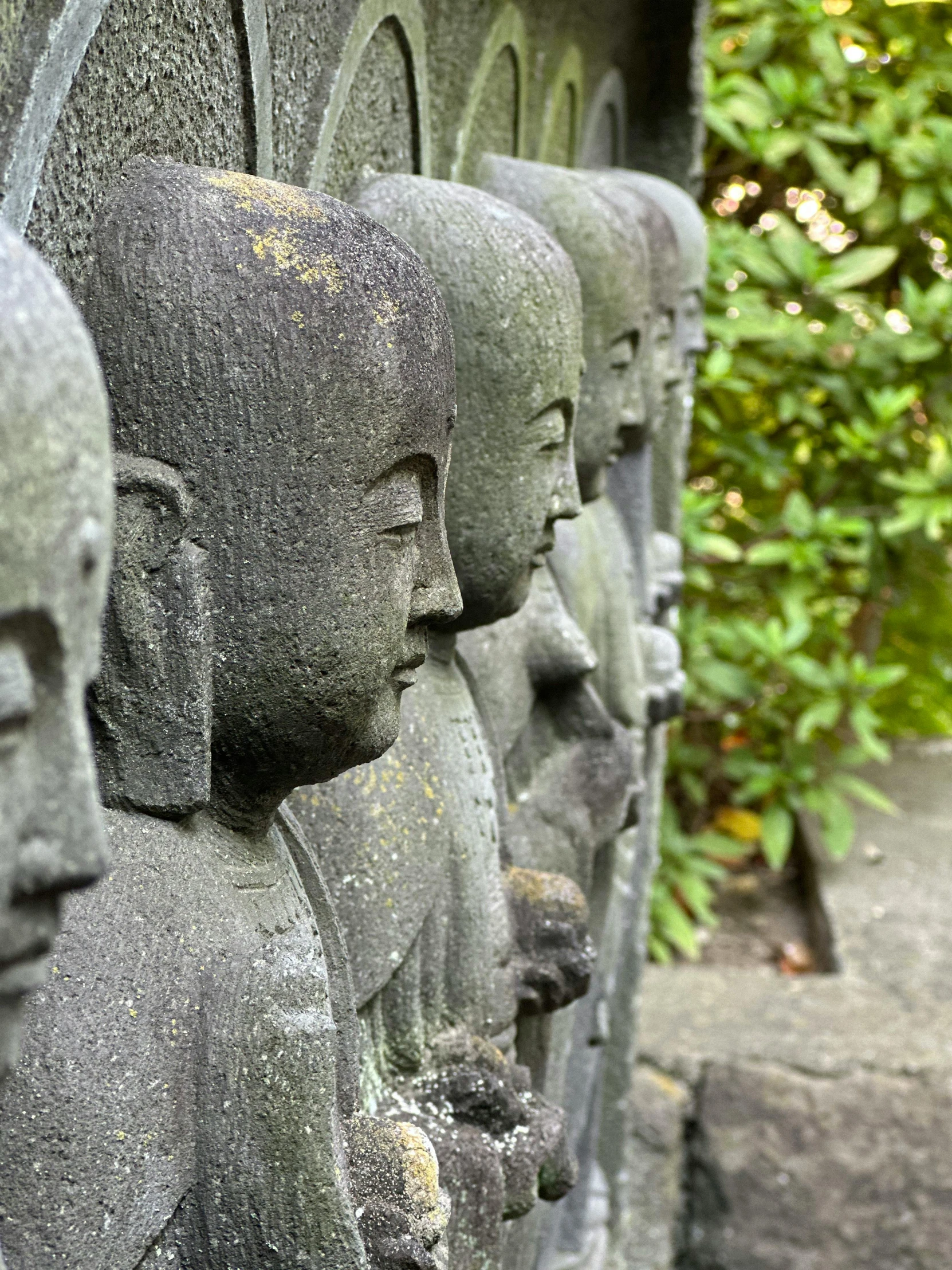 many buddhas with their heads together in various poses