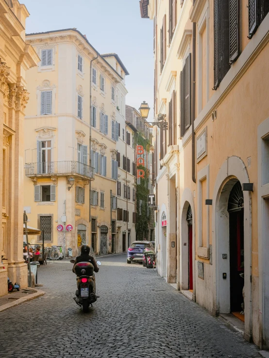 there is a motorcycle driving through the city streets