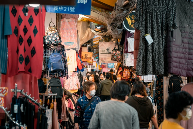 the busy market has a lot of hanging fabrics