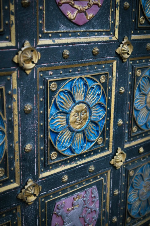 blue decorative designs on a wall and wooden doors