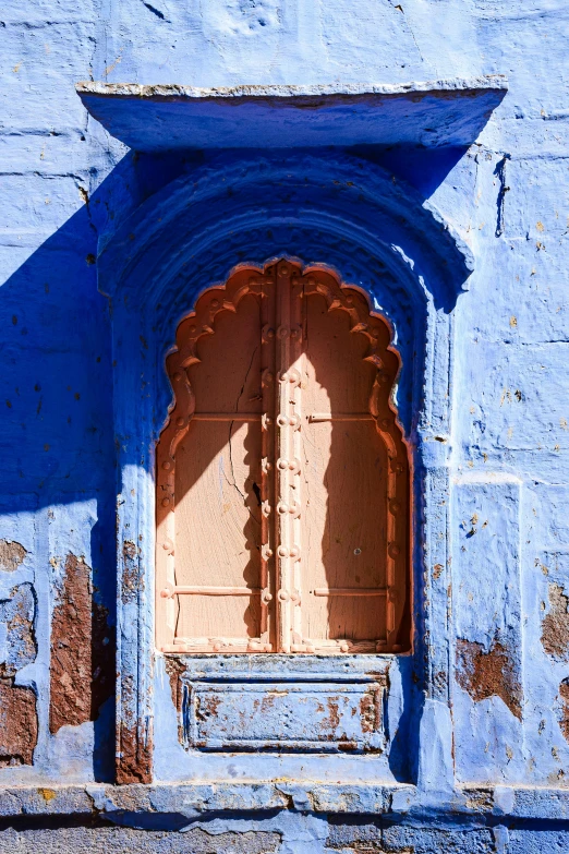 the blue wall is decorated with ornate carvings