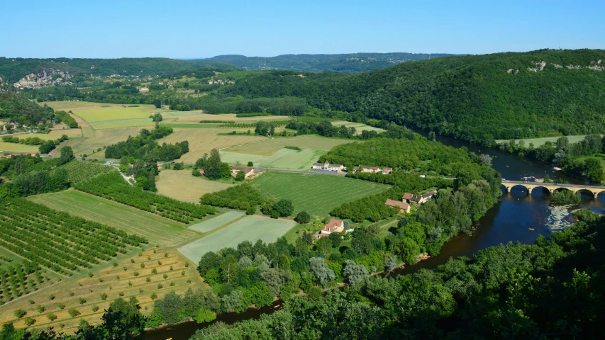 an aerial view of a river flowing through countrysides