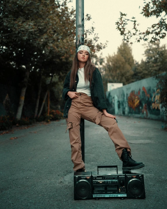 a woman sitting on a pole with a radio