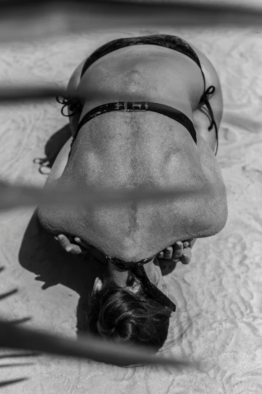 a woman laying in the water on top of a surfboard