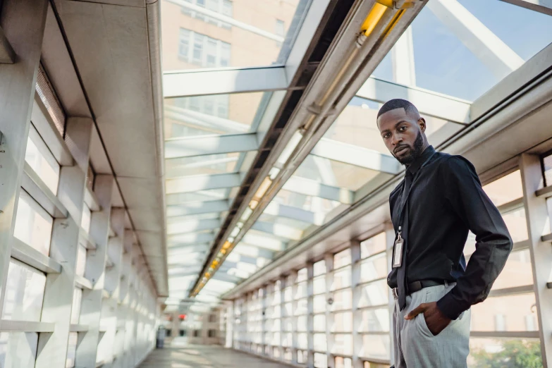 man standing near wall and looking ahead in urban setting