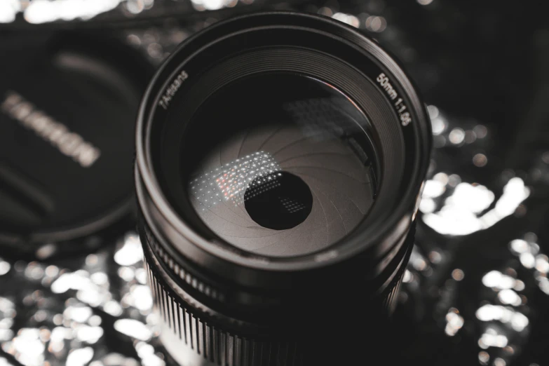 a lens with the lid turned away on shiny objects