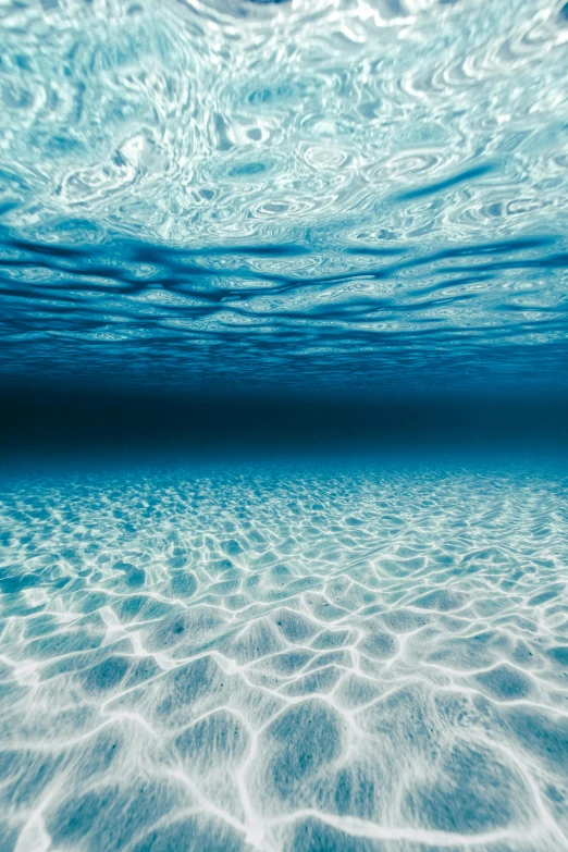 a clear ocean has light reflections on the water surface