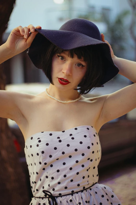 a girl wearing a hat in the 1950s