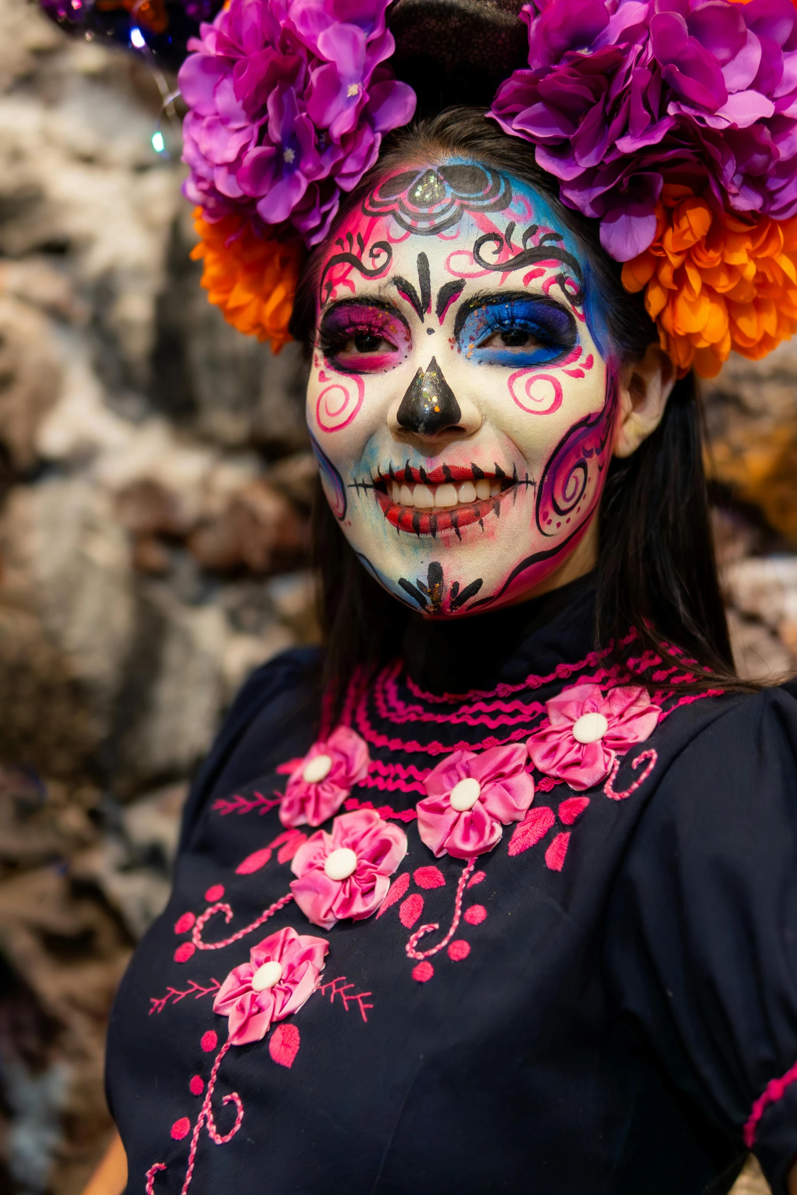 woman wearing floral make - up and purple flowers in her hair