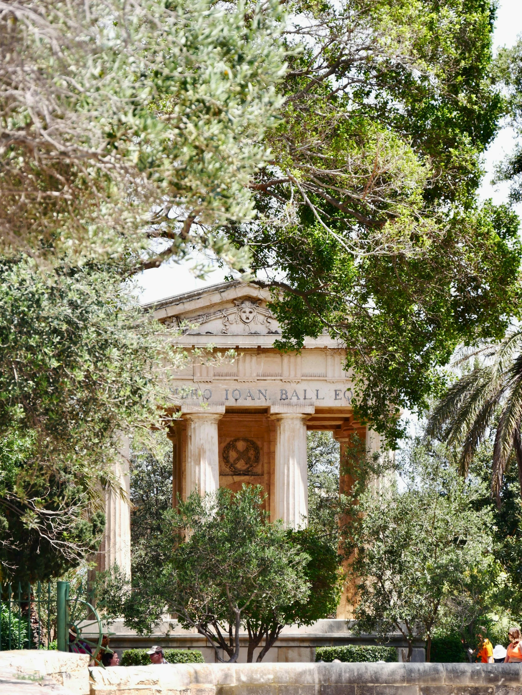 a building in the park is surrounded by trees