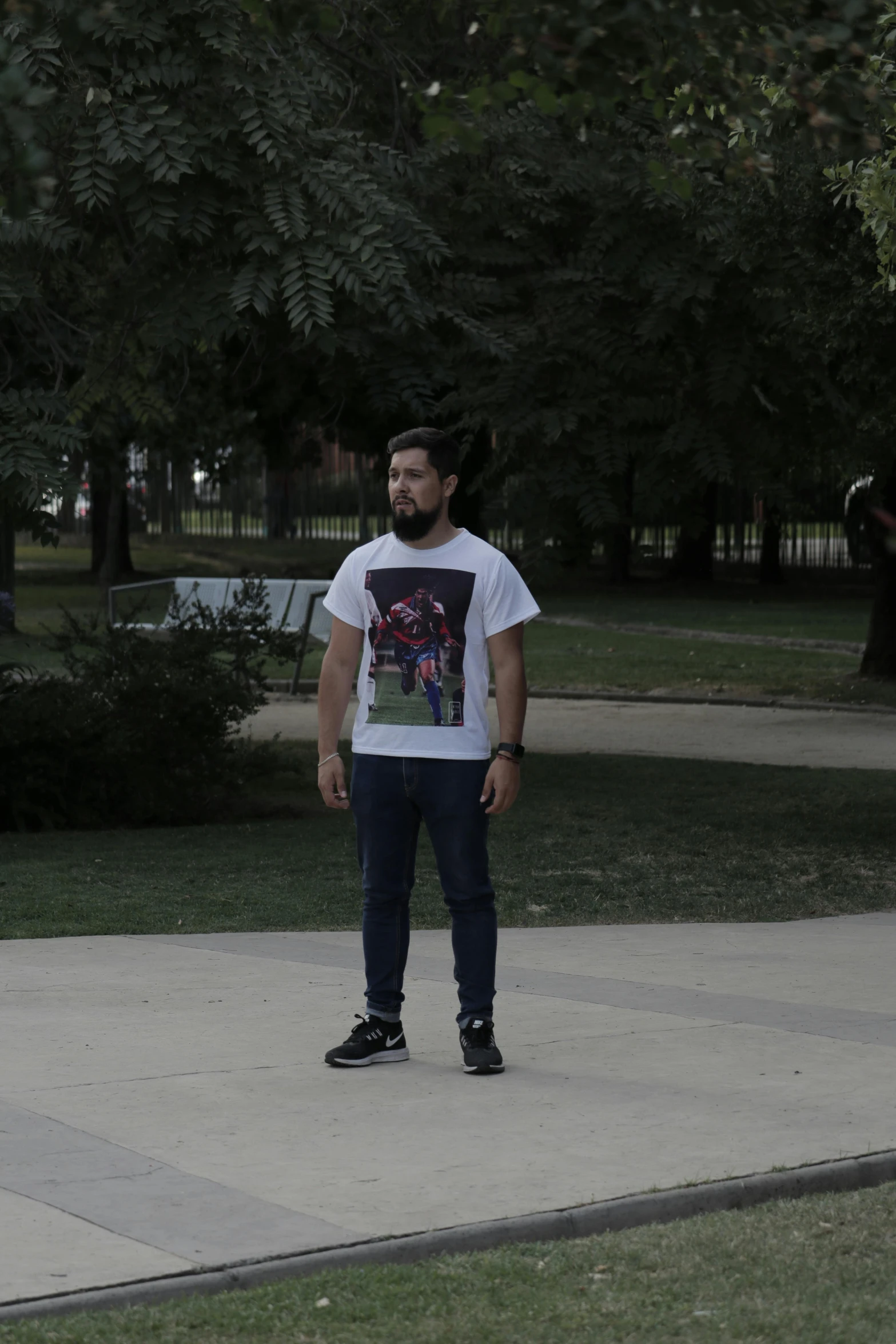 a man standing on top of a cement slab in a park